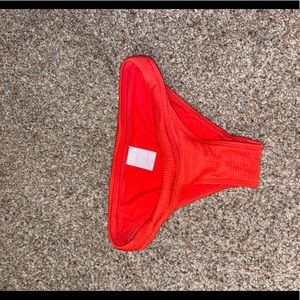 Red swim bottoms size S with ribbed detailing. Never worn.